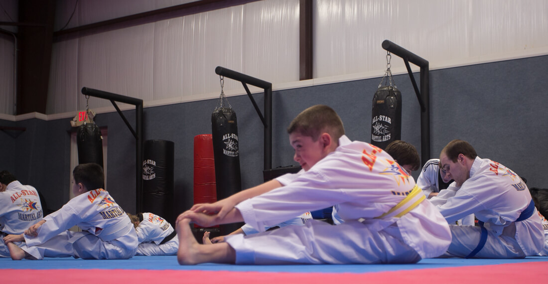 Inspiring-Possibilities-martial-arts-special-needs-slider-_0002_boy-stretching