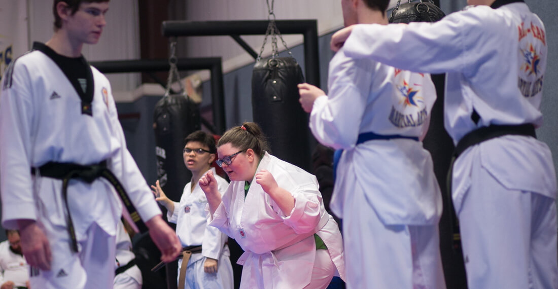 Inspiring-Possibilities-martial-arts-special-needs-slider-_0004_girl-celebrating